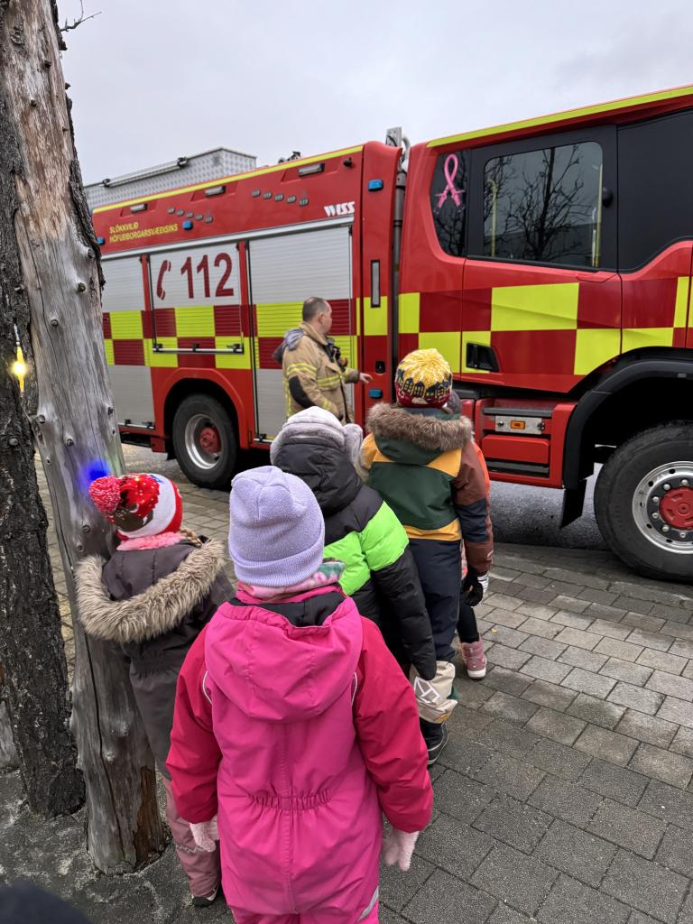 Third-grade students at Klébergsskóli examine a fire truck.